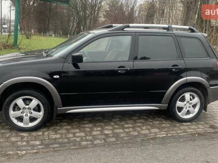 Черный Мицубиси Аутлендер, объемом двигателя 2 л и пробегом 300 тыс. км за 6500 $, фото 1 на Automoto.ua