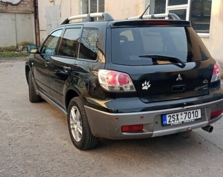 Черный Мицубиси Аутлендер, объемом двигателя 2.4 л и пробегом 243 тыс. км за 1846 $, фото 1 на Automoto.ua