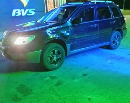 Черный Мицубиси Аутлендер, объемом двигателя 2.4 л и пробегом 250 тыс. км за 4200 $, фото 1 на Automoto.ua