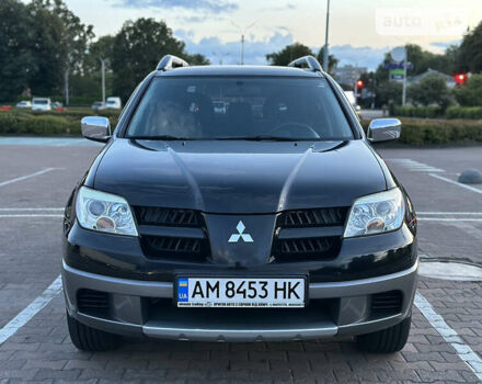Черный Мицубиси Аутлендер, объемом двигателя 2 л и пробегом 205 тыс. км за 6500 $, фото 1 на Automoto.ua