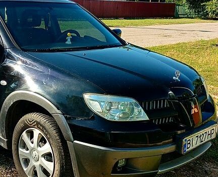 Чорний Міцубісі Аутлендер, об'ємом двигуна 2.4 л та пробігом 230 тис. км за 5600 $, фото 1 на Automoto.ua
