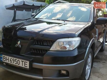 Чорний Міцубісі Аутлендер, об'ємом двигуна 2.4 л та пробігом 210 тис. км за 7500 $, фото 1 на Automoto.ua