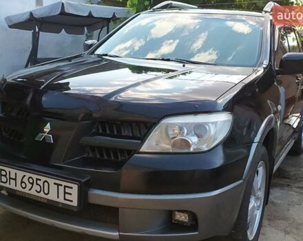 Черный Мицубиси Аутлендер, объемом двигателя 2.4 л и пробегом 210 тыс. км за 7500 $, фото 1 на Automoto.ua