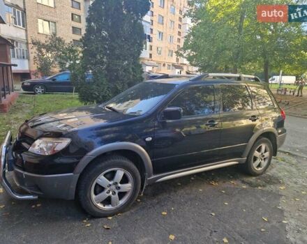 Черный Мицубиси Аутлендер, объемом двигателя 2 л и пробегом 74 тыс. км за 6300 $, фото 1 на Automoto.ua