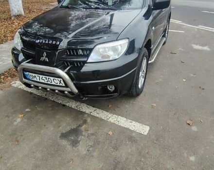 Черный Мицубиси Аутлендер, объемом двигателя 2 л и пробегом 330 тыс. км за 4997 $, фото 1 на Automoto.ua