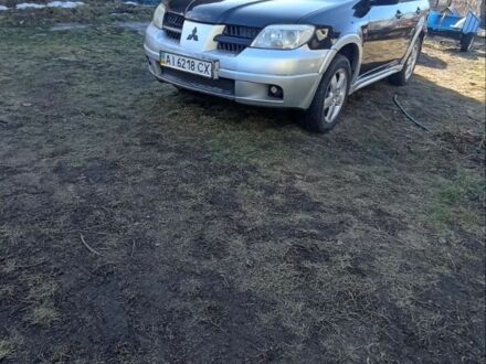 Черный Мицубиси Аутлендер, объемом двигателя 2.4 л и пробегом 370 тыс. км за 4800 $, фото 1 на Automoto.ua