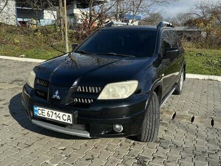 Чорний Міцубісі Аутлендер, об'ємом двигуна 2.4 л та пробігом 307 тис. км за 5600 $, фото 1 на Automoto.ua
