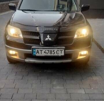 Черный Мицубиси Аутлендер, объемом двигателя 2 л и пробегом 380 тыс. км за 5000 $, фото 1 на Automoto.ua