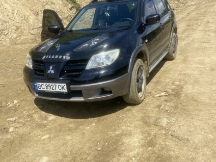 Черный Мицубиси Аутлендер, объемом двигателя 2.4 л и пробегом 226 тыс. км за 5000 $, фото 1 на Automoto.ua
