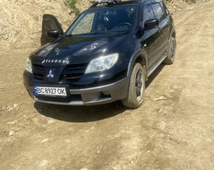 Черный Мицубиси Аутлендер, объемом двигателя 2.4 л и пробегом 226 тыс. км за 5000 $, фото 1 на Automoto.ua