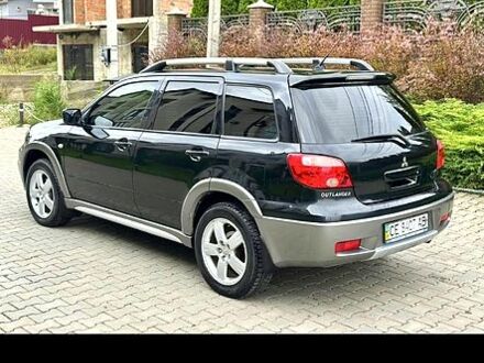 Черный Мицубиси Аутлендер, объемом двигателя 2 л и пробегом 74 тыс. км за 6500 $, фото 1 на Automoto.ua