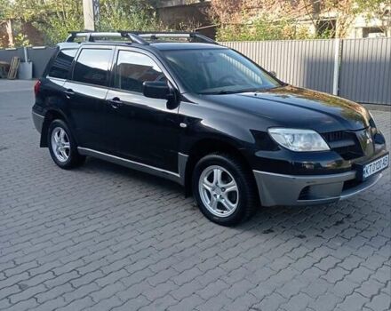 Черный Мицубиси Аутлендер, объемом двигателя 2 л и пробегом 297 тыс. км за 4550 $, фото 1 на Automoto.ua