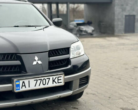 Черный Мицубиси Аутлендер, объемом двигателя 2 л и пробегом 297 тыс. км за 6200 $, фото 1 на Automoto.ua