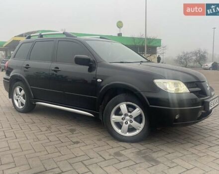 Черный Мицубиси Аутлендер, объемом двигателя 2.4 л и пробегом 277 тыс. км за 6700 $, фото 1 на Automoto.ua