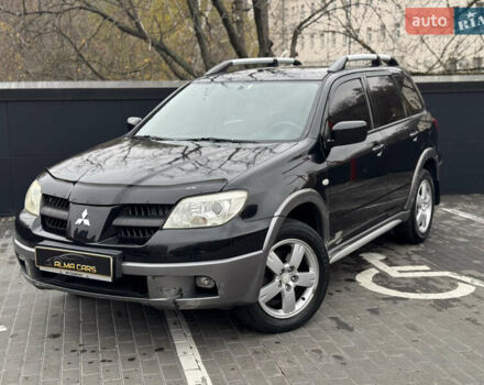 Черный Мицубиси Аутлендер, объемом двигателя 2.4 л и пробегом 242 тыс. км за 6800 $, фото 1 на Automoto.ua