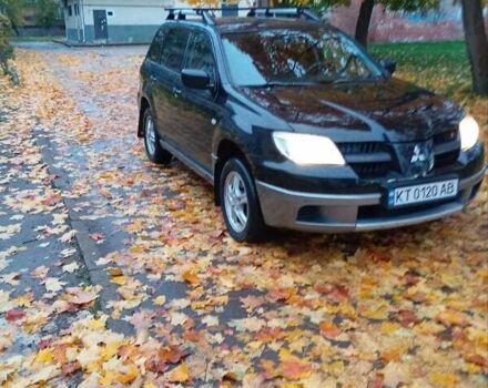 Черный Мицубиси Аутлендер, объемом двигателя 2 л и пробегом 297 тыс. км за 5800 $, фото 1 на Automoto.ua