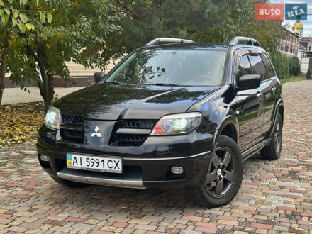 Чорний Міцубісі Аутлендер, об'ємом двигуна 2.38 л та пробігом 247 тис. км за 5499 $, фото 1 на Automoto.ua