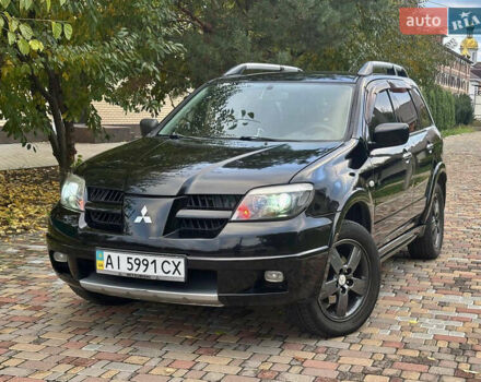 Чорний Міцубісі Аутлендер, об'ємом двигуна 2.38 л та пробігом 247 тис. км за 5499 $, фото 1 на Automoto.ua