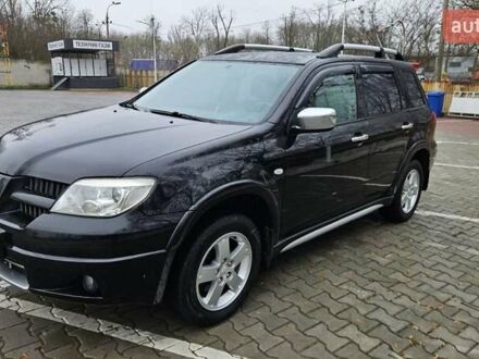 Черный Мицубиси Аутлендер, объемом двигателя 2.4 л и пробегом 167 тыс. км за 6150 $, фото 1 на Automoto.ua