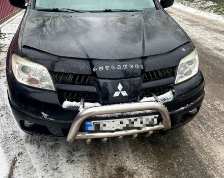 Черный Мицубиси Аутлендер, объемом двигателя 2 л и пробегом 300 тыс. км за 4600 $, фото 1 на Automoto.ua