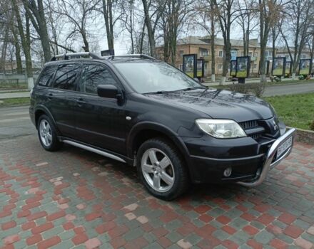 Черный Мицубиси Аутлендер, объемом двигателя 2 л и пробегом 200 тыс. км за 5100 $, фото 1 на Automoto.ua