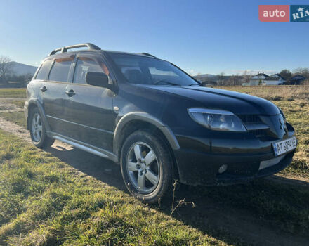 Черный Мицубиси Аутлендер, объемом двигателя 2.38 л и пробегом 230 тыс. км за 5350 $, фото 1 на Automoto.ua