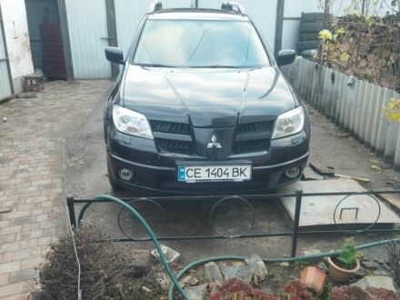 Черный Мицубиси Аутлендер, объемом двигателя 2.4 л и пробегом 280 тыс. км за 5455 $, фото 1 на Automoto.ua