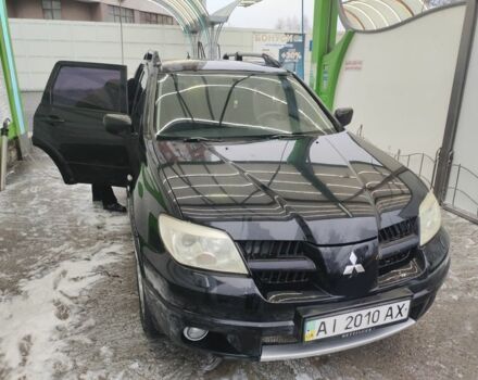 Черный Мицубиси Аутлендер, объемом двигателя 2.4 л и пробегом 360 тыс. км за 5200 $, фото 1 на Automoto.ua