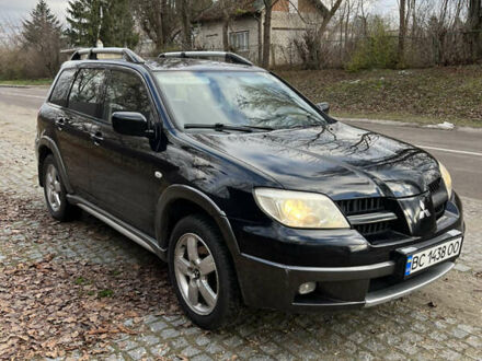 Черный Мицубиси Аутлендер, объемом двигателя 2.4 л и пробегом 309 тыс. км за 4700 $, фото 1 на Automoto.ua