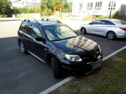 Чорний Міцубісі Аутлендер, об'ємом двигуна 2.4 л та пробігом 240 тис. км за 5700 $, фото 1 на Automoto.ua