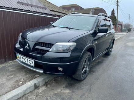 Черный Мицубиси Аутлендер, объемом двигателя 2.4 л и пробегом 234 тыс. км за 5499 $, фото 1 на Automoto.ua