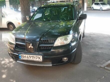 Черный Мицубиси Аутлендер, объемом двигателя 2.4 л и пробегом 248 тыс. км за 7000 $, фото 1 на Automoto.ua