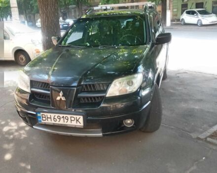 Черный Мицубиси Аутлендер, объемом двигателя 2.4 л и пробегом 248 тыс. км за 7000 $, фото 1 на Automoto.ua