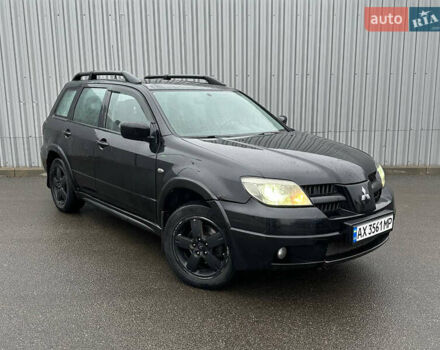 Черный Мицубиси Аутлендер, объемом двигателя 2.38 л и пробегом 175 тыс. км за 6000 $, фото 1 на Automoto.ua