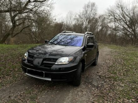 Черный Мицубиси Аутлендер, объемом двигателя 2.4 л и пробегом 200 тыс. км за 5800 $, фото 1 на Automoto.ua