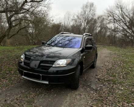 Черный Мицубиси Аутлендер, объемом двигателя 2.4 л и пробегом 200 тыс. км за 5800 $, фото 1 на Automoto.ua