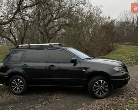 Черный Мицубиси Аутлендер, объемом двигателя 2.38 л и пробегом 215 тыс. км за 5800 $, фото 1 на Automoto.ua