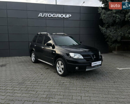 Черный Мицубиси Аутлендер, объемом двигателя 2.4 л и пробегом 248 тыс. км за 7300 $, фото 1 на Automoto.ua