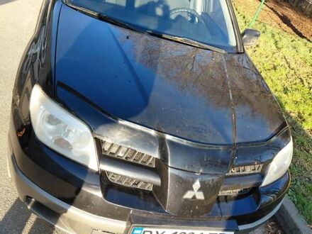 Черный Мицубиси Аутлендер, объемом двигателя 2 л и пробегом 260 тыс. км за 5500 $, фото 1 на Automoto.ua