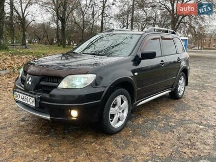 Черный Мицубиси Аутлендер, объемом двигателя 2.4 л и пробегом 213 тыс. км за 6850 $, фото 1 на Automoto.ua