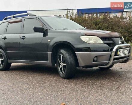 Черный Мицубиси Аутлендер, объемом двигателя 2 л и пробегом 295 тыс. км за 5300 $, фото 1 на Automoto.ua