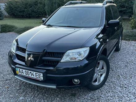 Черный Мицубиси Аутлендер, объемом двигателя 2.38 л и пробегом 118 тыс. км за 6850 $, фото 1 на Automoto.ua