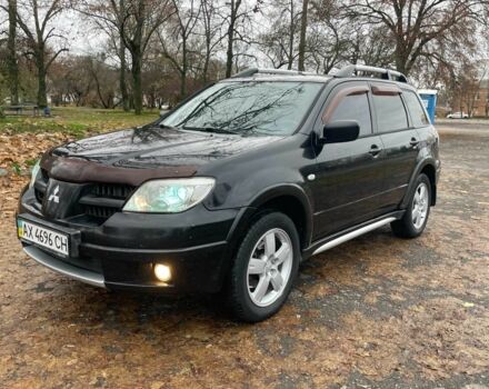 Черный Мицубиси Аутлендер, объемом двигателя 2.4 л и пробегом 213 тыс. км за 6850 $, фото 1 на Automoto.ua