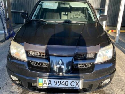 Черный Мицубиси Аутлендер, объемом двигателя 2.4 л и пробегом 219 тыс. км за 6000 $, фото 1 на Automoto.ua