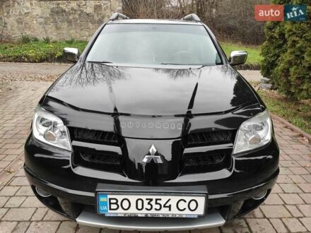 Черный Мицубиси Аутлендер, объемом двигателя 2 л и пробегом 180 тыс. км за 6000 $, фото 1 на Automoto.ua