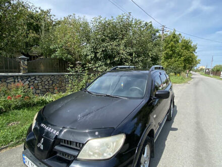 Черный Мицубиси Аутлендер, объемом двигателя 2.38 л и пробегом 256 тыс. км за 5950 $, фото 1 на Automoto.ua