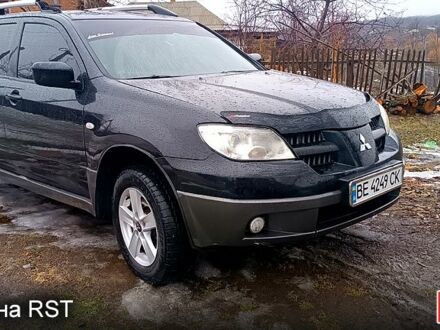 Черный Мицубиси Аутлендер, объемом двигателя 2 л и пробегом 250 тыс. км за 5850 $, фото 1 на Automoto.ua