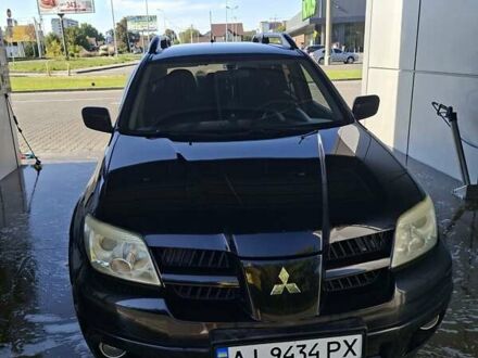 Черный Мицубиси Аутлендер, объемом двигателя 2.4 л и пробегом 270 тыс. км за 6900 $, фото 1 на Automoto.ua