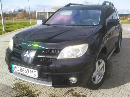 Черный Мицубиси Аутлендер, объемом двигателя 2.4 л и пробегом 295 тыс. км за 6800 $, фото 1 на Automoto.ua