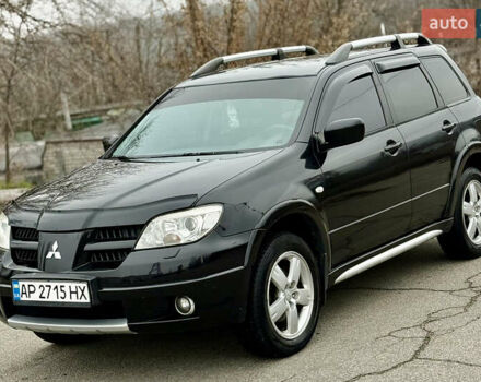Черный Мицубиси Аутлендер, объемом двигателя 2.4 л и пробегом 245 тыс. км за 6500 $, фото 1 на Automoto.ua
